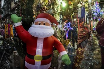 People buy Christmas decorations at market in Kolkata, India